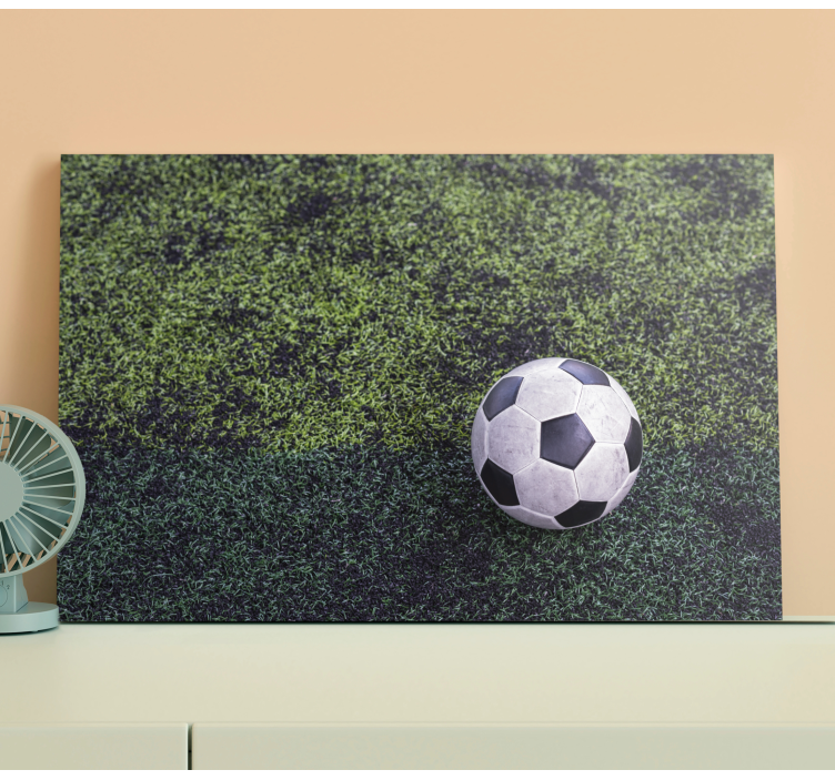 Tableau sports ballon de foot sur herbe - TenStickers